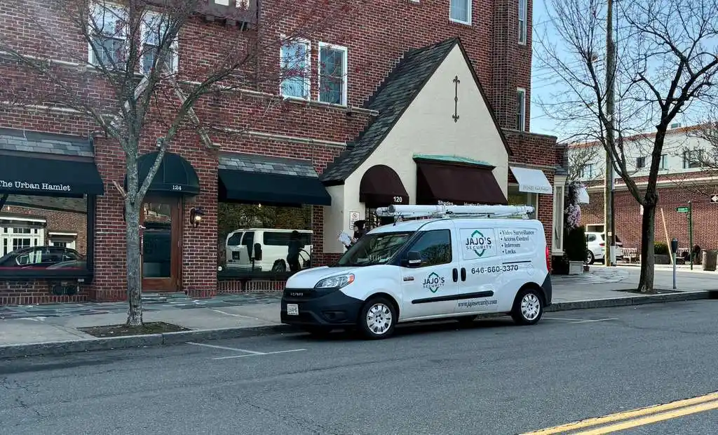 JAJO's Security branded van parked outside a commercial storefront