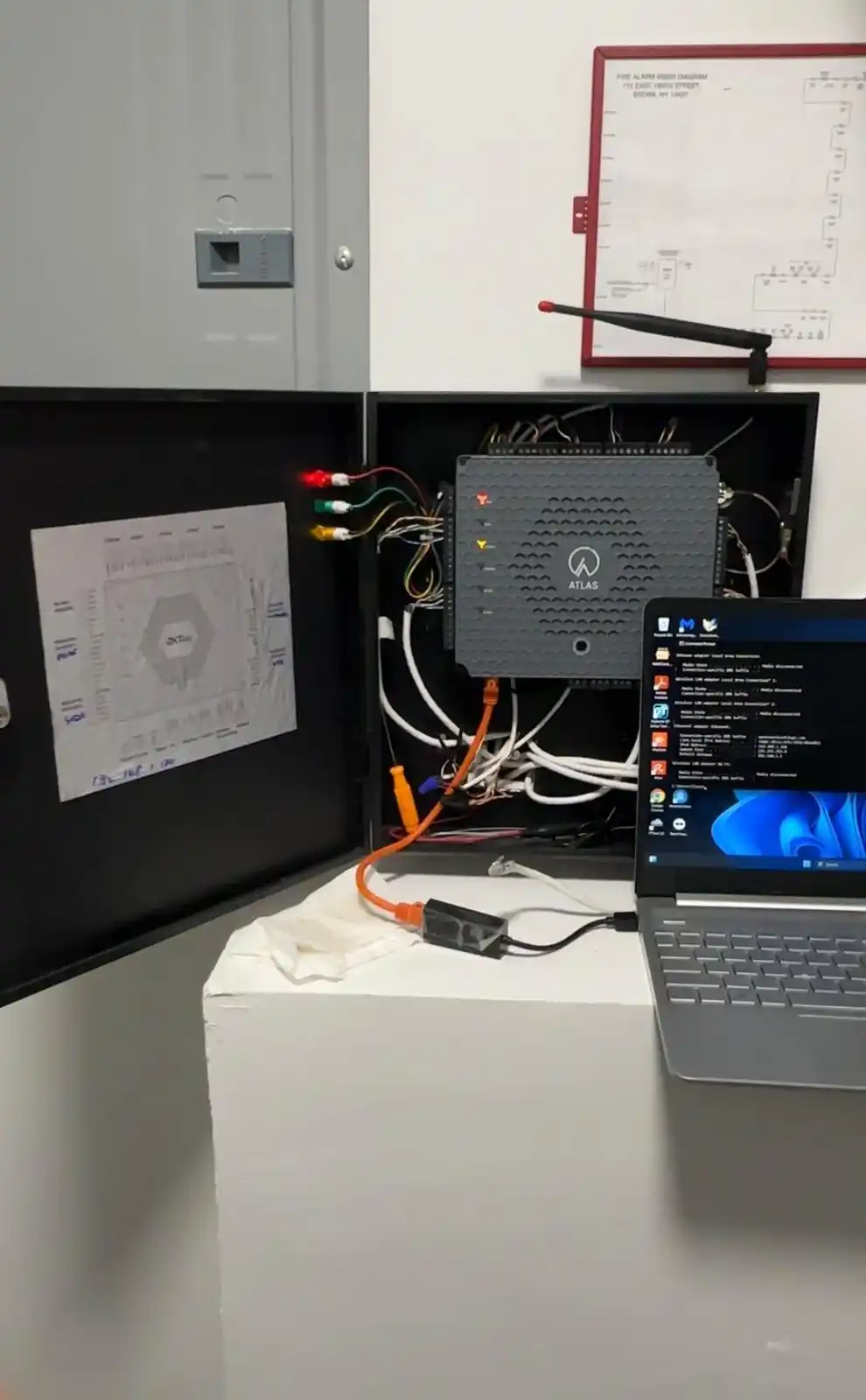 Atlas access control panel open with laptop connected during programming
