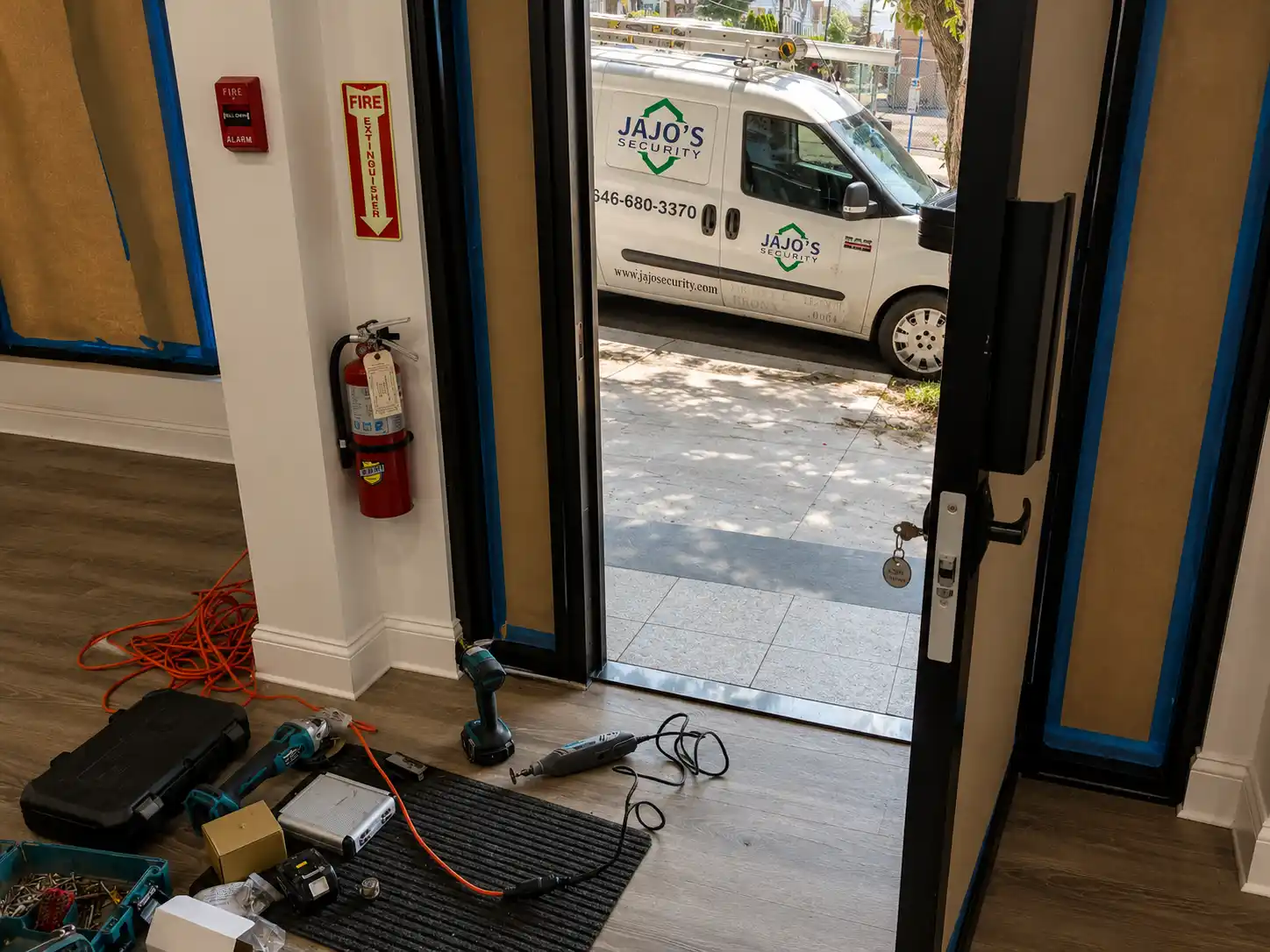 Door hardware service in progress with JAJO's Security van visible outside