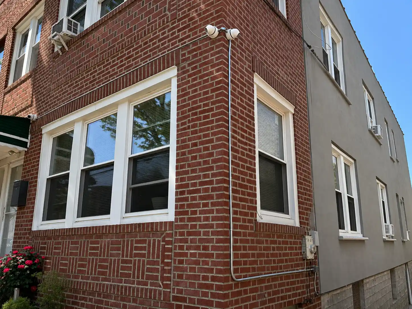 Security camera conduit run on the exterior of a brick townhouse